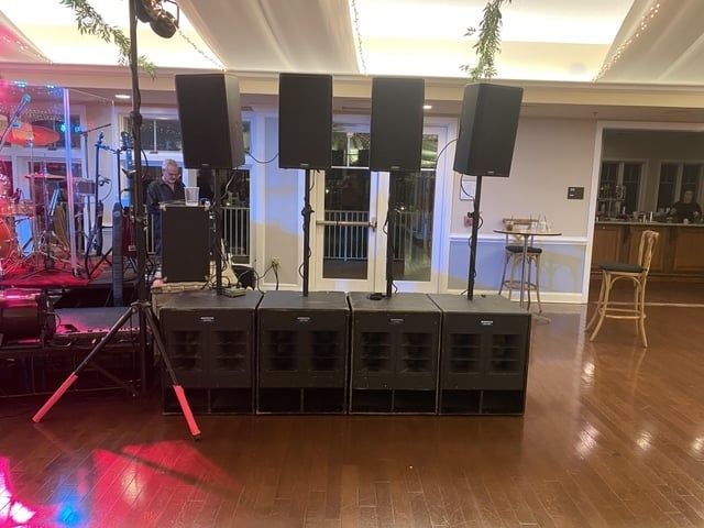 Large speaker array and subwoofers arranged on a polished dance floor